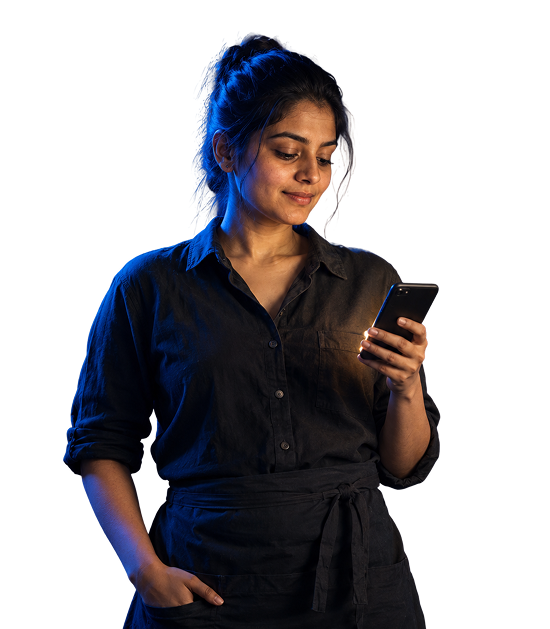 Café owner checking a new WhatsApp order on her phone